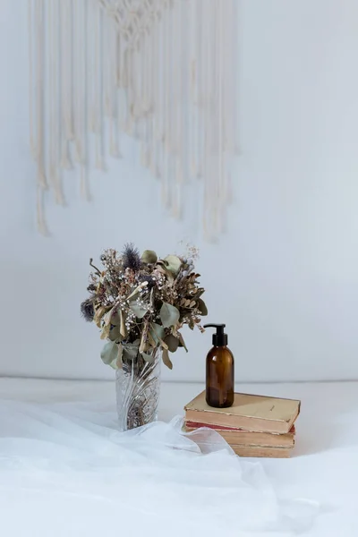 cosmetics on a background of eucalyptus with a book