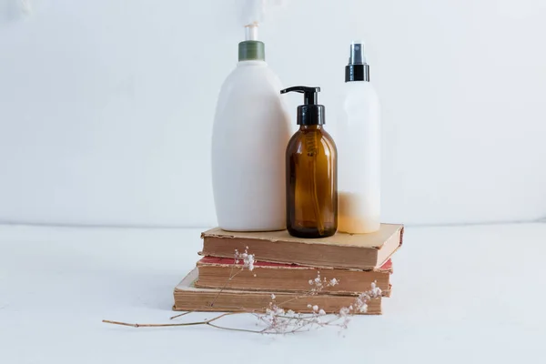 dry eucalyptus in a vase with a book, cosmetic, containers for cosmetics