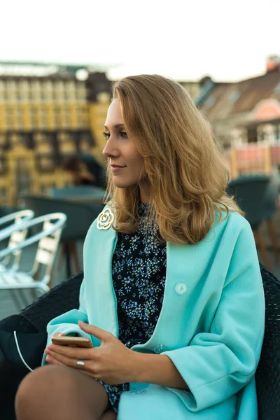 Beautiful blondie sitting on terrace — Stock Photo, Image