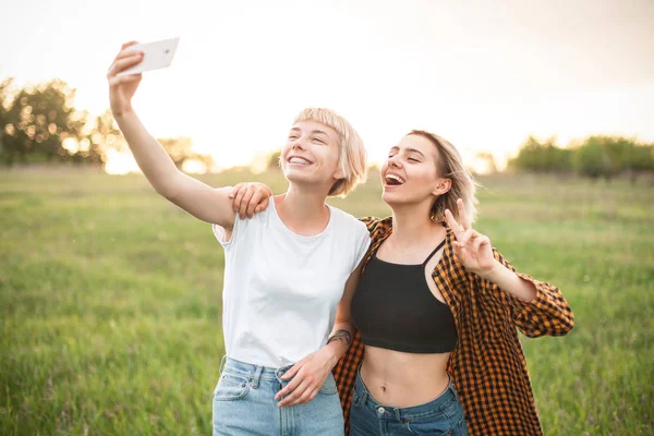 人の若い女性は携帯電話で Selfie を撮影します 親友たちです — ストック写真