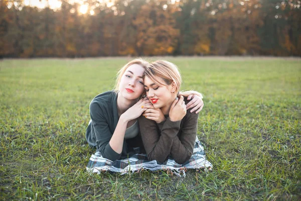 两个年轻女子躺在草地上 — 图库照片