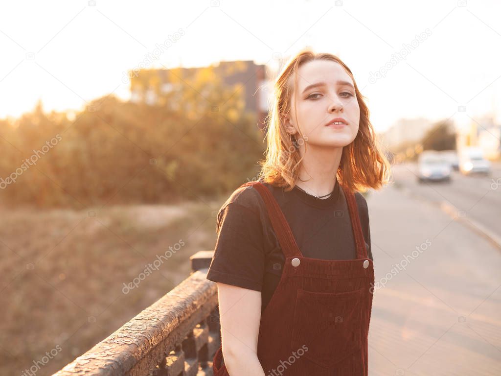 Young woman walking on the street at sunset