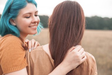 İki kadın açık havada sarılıyor. En iyi dostlar