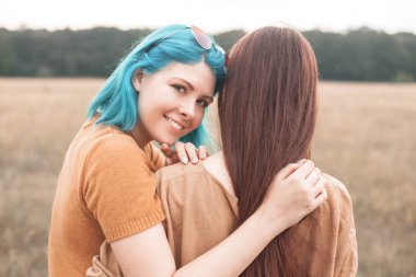 İki kadın açık havada sarılıyor. En iyi dostlar