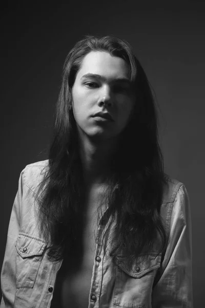 Portrait of the man with long hair. Black and white