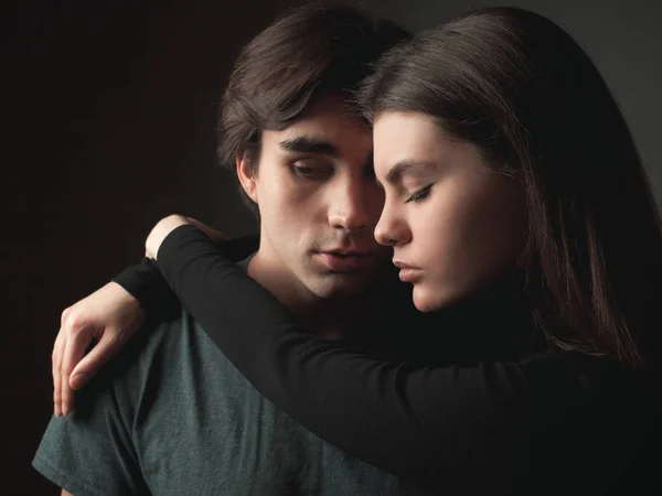 Couple in love on the black background. Studio