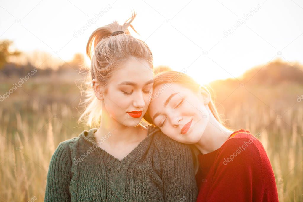 Two young women spend time together at sunset. Best friends