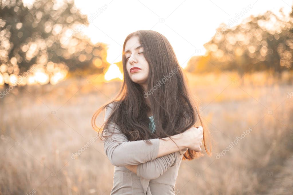 Portrait of a gentle young woman outdoors. Eyes closed