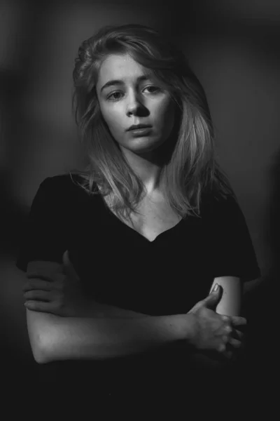 Portrait of sad young woman. Black and white. Low key