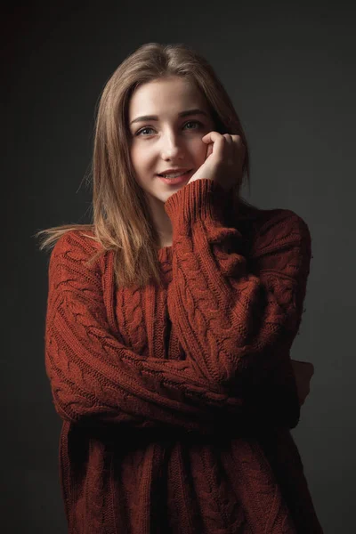 Beautiful young woman in red sweater.