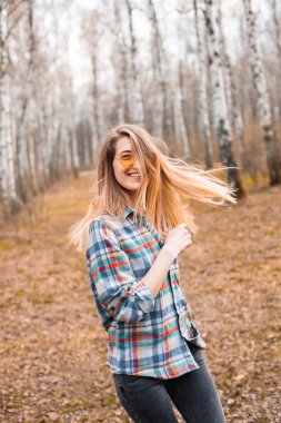 Huş bahçesinde yürüyen mutlu genç kadın