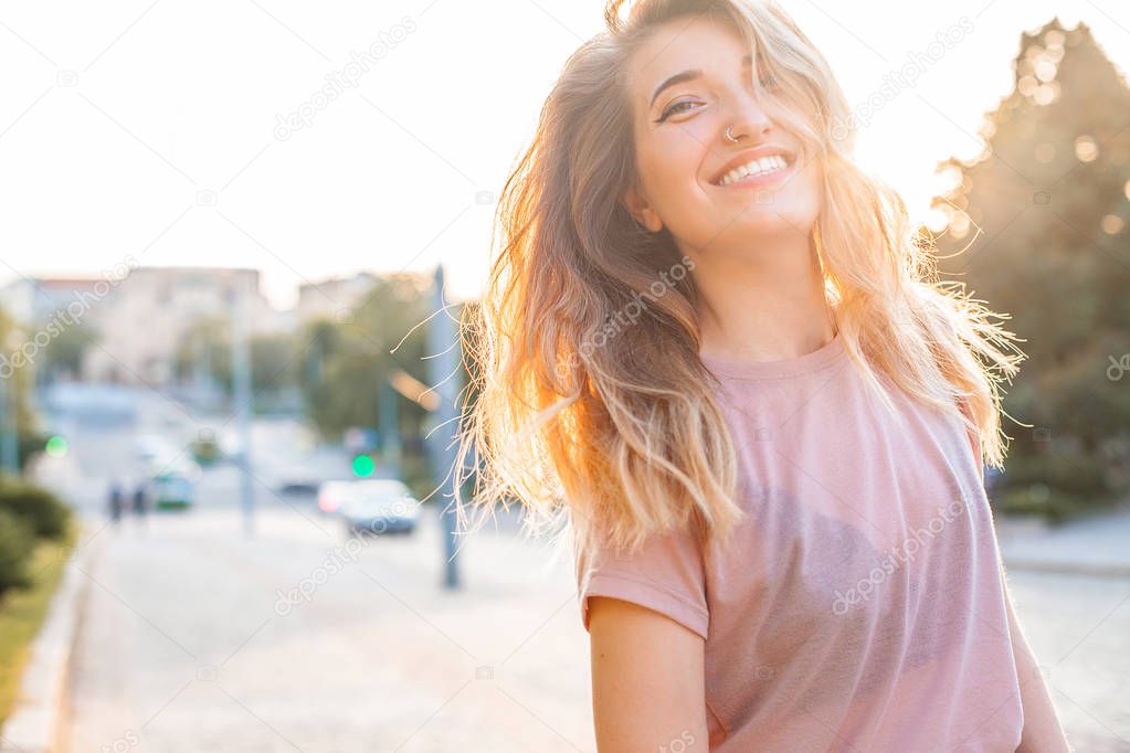 Happy young woman walking in the city,