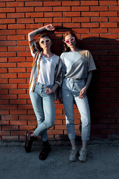 Two Young Women Standing Brick Wall — Stock Photo, Image