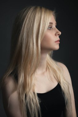 Portrait of young woman with beautiful blonde hair. Profile clipart