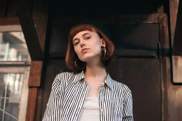 Fashionable young woman standing on the porch. Close up.