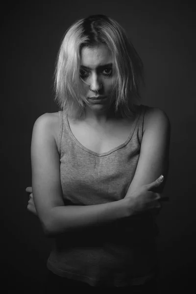 Portrait of sad woman with smeared make up. Black and white