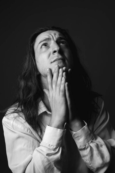 Portrait of depressed man with long hair. Black and white