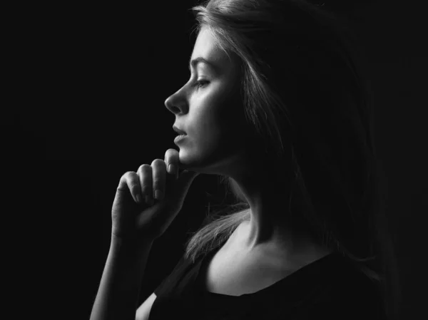 Portrait of young woman in profile. Black and white.