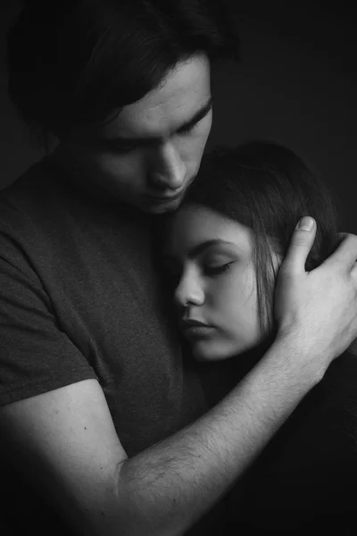 Portrait of young couple in love. Black and white Low key