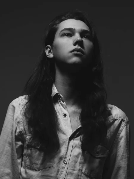 Portrait of young man in studio. Black and white.