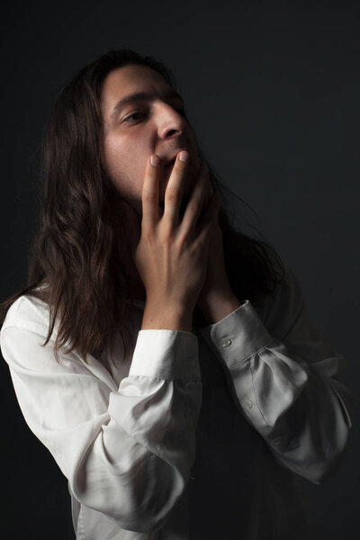 Portrait of a worried young man. Low key