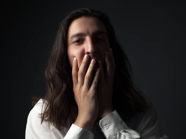 Portrait of a worried young man. Low key