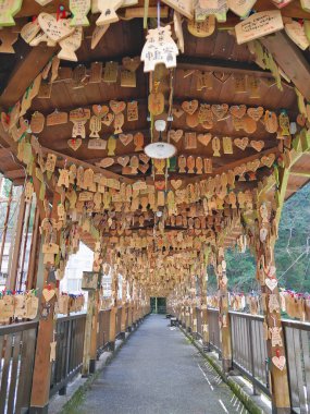 TSUETATE, JAPAN - APRIL 1, 2017: Ema or carp-shaped cedar wishing plaques hanged at Momiji bridge or Maple bridge in Tsuetate onsen during Koinobori festival