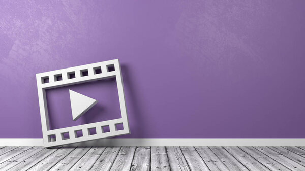 Символ воспроизведения фильма на деревянном полу напротив стены
