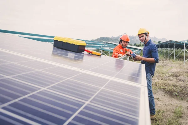 engineer in solar power plant working on installing solar panel