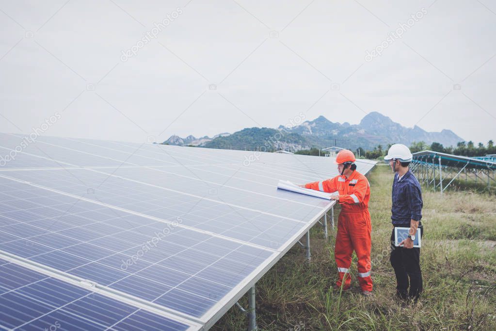 engineer in solar power plant working on installing solar panel 