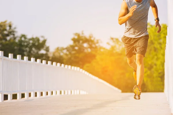 Young man runner running on running road in city park — Stock Photo, Image