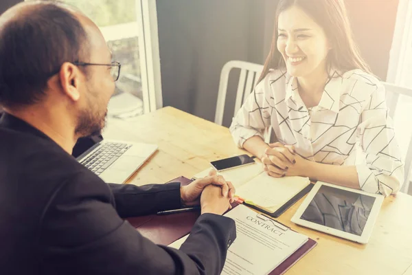 Business negotiation concept; Business people handshaking to sig