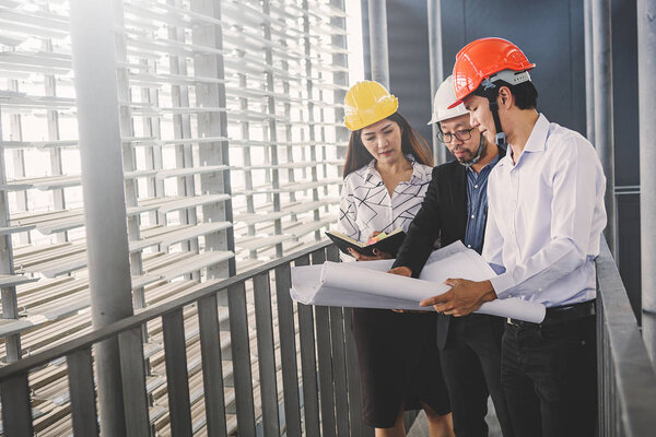 Consultant engineer discussing construction project in blueprint