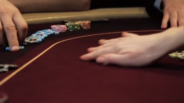 Playing poker. Woman is nervous, fingering the chips in her hand on the poker table. Hand close up. Casino gamble. — Stock Video