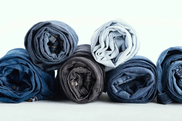 Stack Different Rolled Jeans White Background — Stock Photo, Image