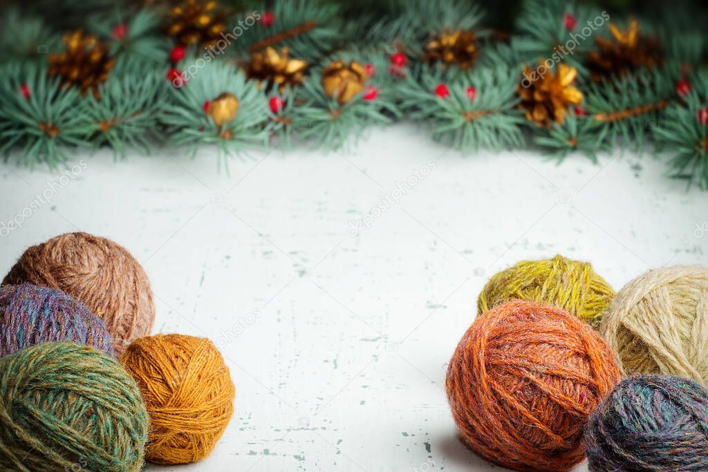 Balls of wool yarn on a Christmas tree background