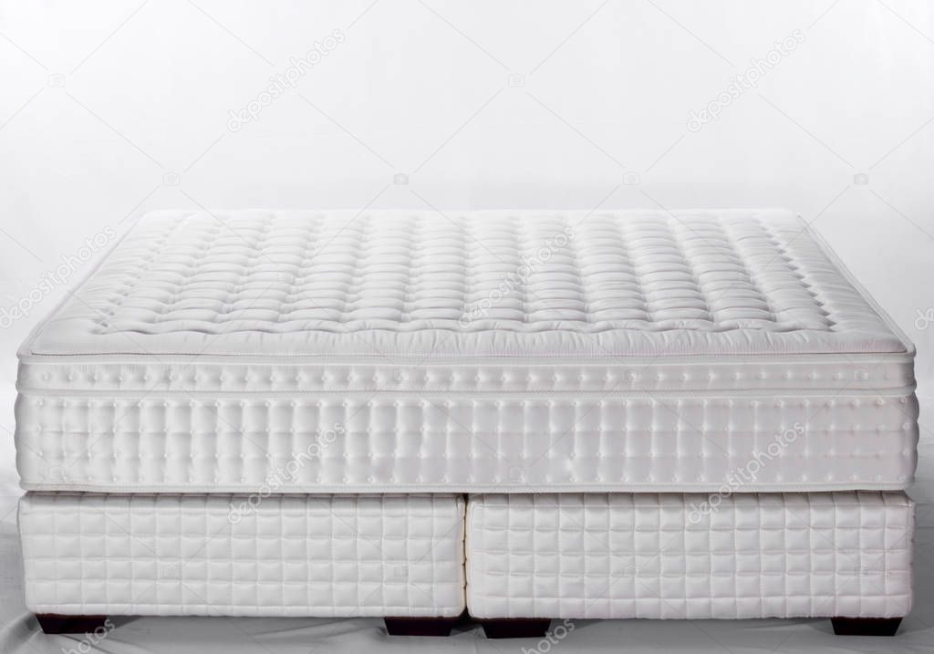 close up of white and grey mattress in light room 