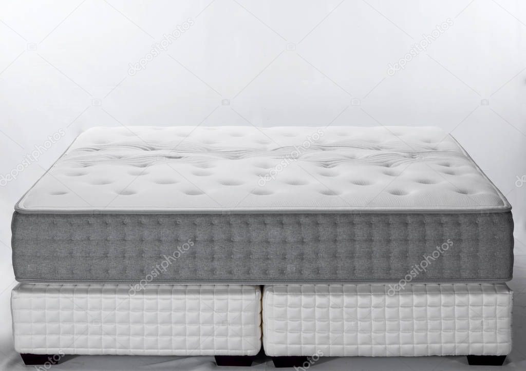 close up of white and grey mattress in light room 