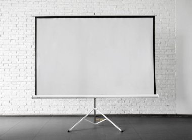 Ekran beyaz duvara yakın yerleştirilen projektör