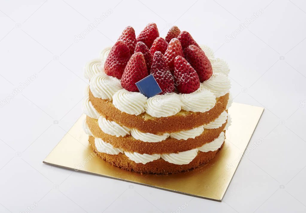 Closeup of sweet homemade cake decorated with strawberries, isolated on white background 