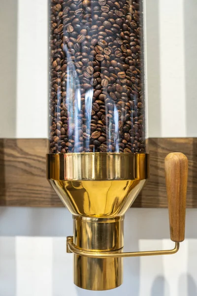 Closeup photo of coffee beans contained within transparent canister — Stock Photo, Image