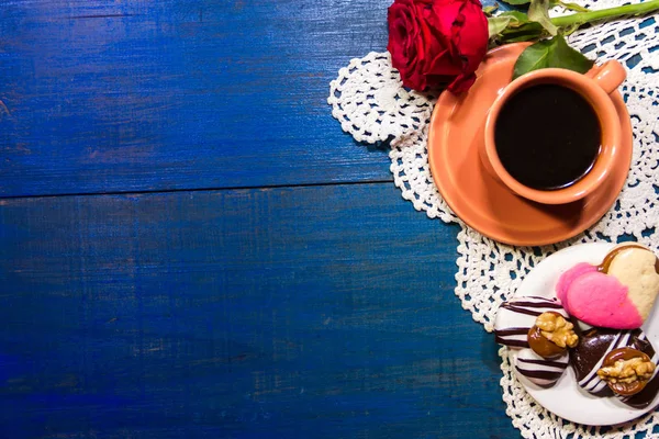 romantic flowers with coffee and sweet treats on the table