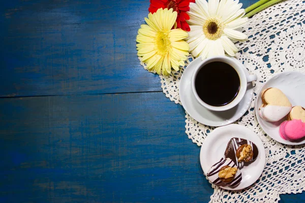 romantic flowers with coffee and sweet treats on the table