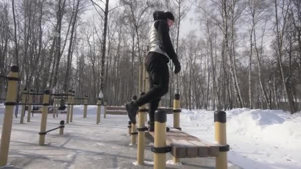 Fitness man jumping on bench during workout training on sport ground — Stock Video