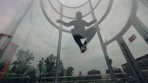 Man skydiver flies in wind tunnel. Flying in a wind tunnel. Extreme sports