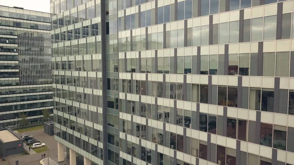 Reflection in glass windows business building. City building and city road car