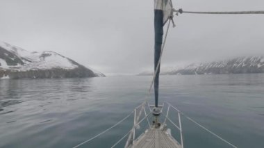 Yay görünümünden gemi yelken karlı dağlar ve deniz cliff peyzaj
