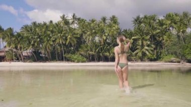 Güzel bir kadın, yaz günü banyo sonra deniz suyu tropikal Adası'nda yürürken. Genç kadın mayo okyanus plaj ve tropikal palmiye ağacı kıyısında. Cennet plaj üzerinde mutlu kız.