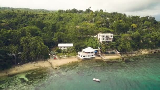 Здания с видом с воздуха на тропический остров на морском пляже. Курортный отель на берегу моря с видом на бирюзовую воду сверху летающего дрона . — стоковое видео