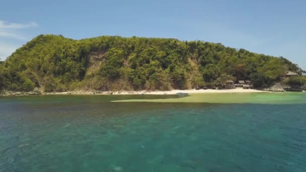 Vue aérienne d'une île tropicale verdoyante avec montagnes, plage de sable et cabanes de pêche . — Video